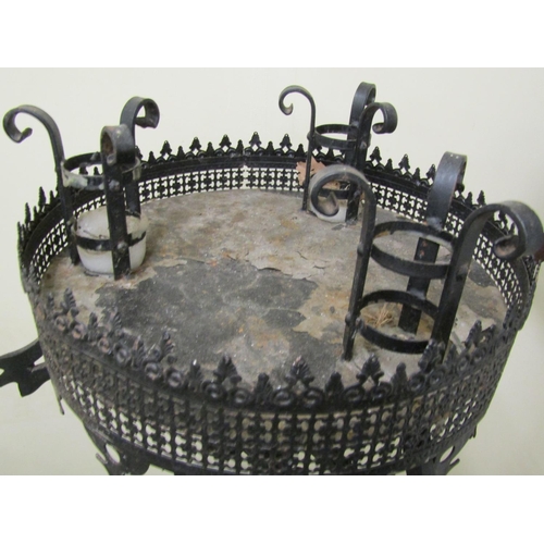 2477 - A pair of good quality had wrought iron candle stands in a Gothic manner, each supporting three cand... 