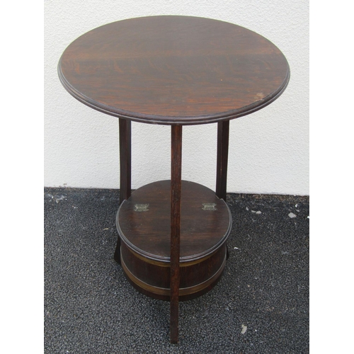 2494 - A Lister & Co work table in oak, the circular top raised on splay supports with enclosed base, a fur... 