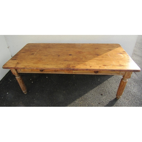 2515 - A stripped pine farmhouse kitchen table, the plank top with two frieze drawers on hexagonal supports... 