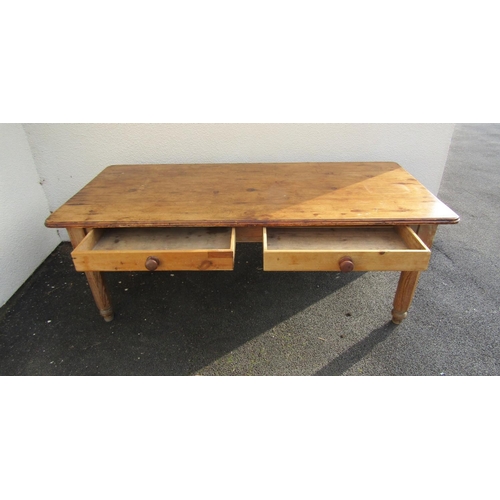 2515 - A stripped pine farmhouse kitchen table, the plank top with two frieze drawers on hexagonal supports... 