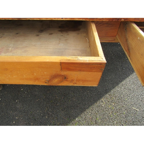 2515 - A stripped pine farmhouse kitchen table, the plank top with two frieze drawers on hexagonal supports... 