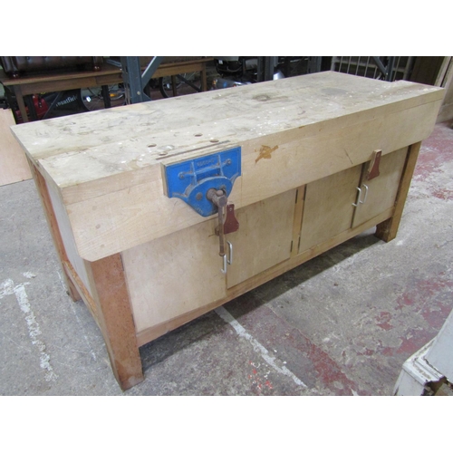 A good workshop bench in mixed timbers with integral vice and enclosed base, 186 cm in length