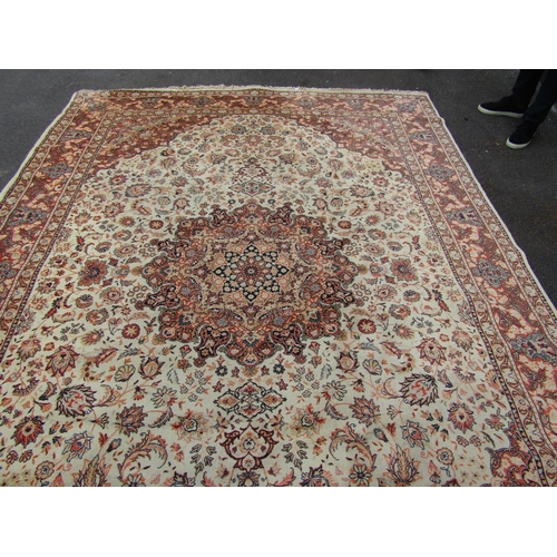 2737 - A Turkish Wilton type machine made rug with traditional Perisan design in tones of cream and orange,... 