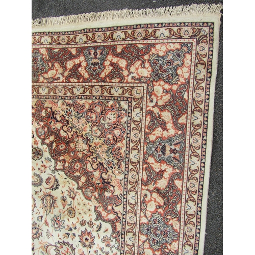 2737 - A Turkish Wilton type machine made rug with traditional Perisan design in tones of cream and orange,... 