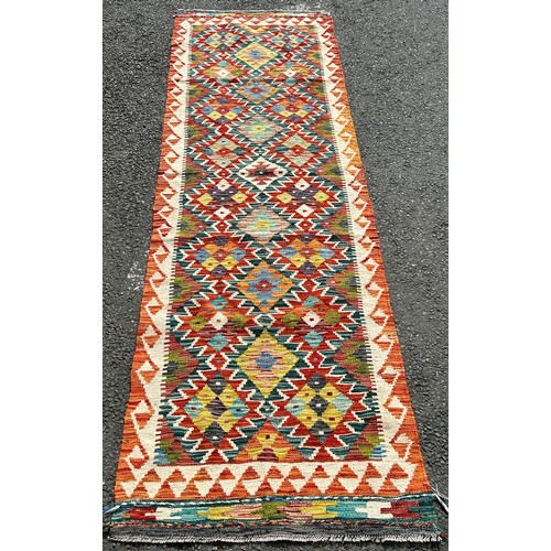 2741 - A Chobi Kilim runner with three rows of alternating stepped and diamond medallions 250 x 75cm approx... 