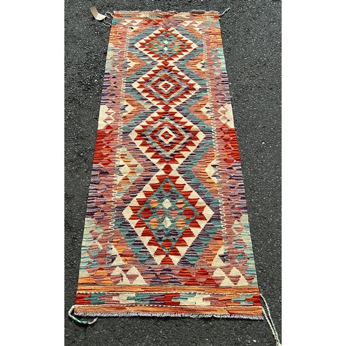 2742 - A Chobi Kilim runner with four multicoloured stepped medallions the centre 189 x 67cm approx.