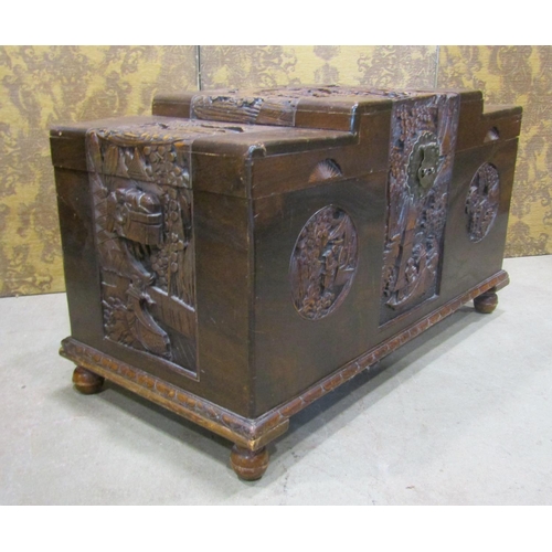 2146 - A Chinese camphor wood coffer with deeply carved landscape and character detail