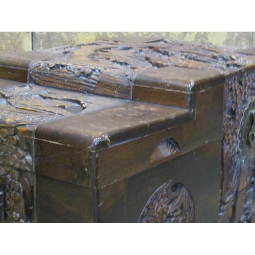 2146 - A Chinese camphor wood coffer with deeply carved landscape and character detail