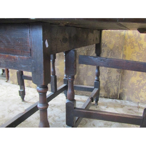 2189 - An 18th century oak gateleg table of usual form on eight turned supports, 110 cm long