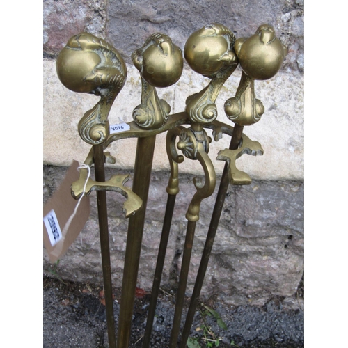 2092 - A cast brass fireside companion set with claw and ball pommels and scrolling tray base, (af)