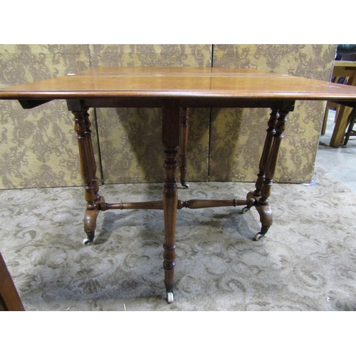 2166 - A Victorian mahogany drop leaf Sutherland tea table raised on turned supports and castors, (af), tog... 