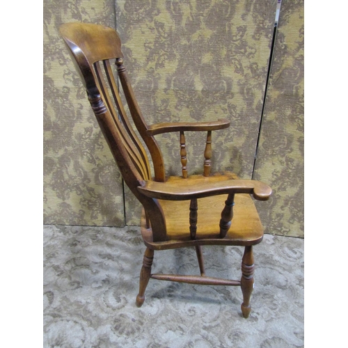 2171 - An antique Windsor stained elm and beechwood lathe back elbow chair with saddle shaped seat