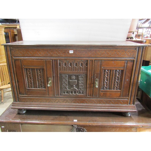 2232 - Antique oak side cupboard enclosed by two doors with additional carved panel work including lamb and... 