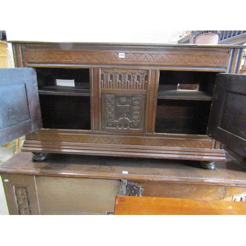 2232 - Antique oak side cupboard enclosed by two doors with additional carved panel work including lamb and... 