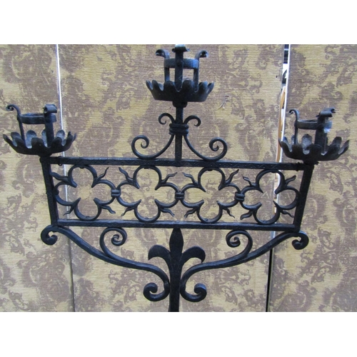 2241 - A good quality heavy wrought iron three branch ecclesiastical pricket candle stand, on tripod base