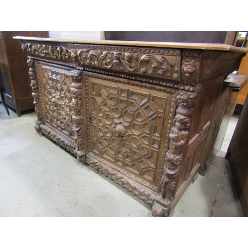 2246 - A substantial Elizabethan style oak side cupboard enclosed by a pair of panelled doors with geometri... 