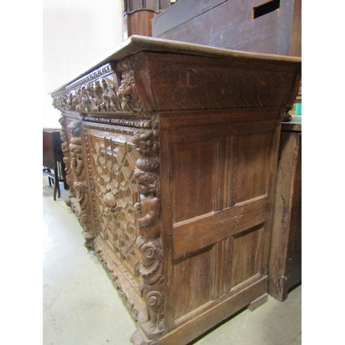 2246 - A substantial Elizabethan style oak side cupboard enclosed by a pair of panelled doors with geometri... 