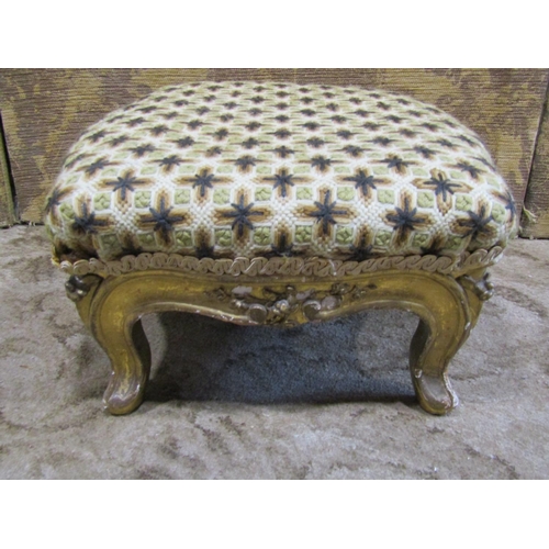 2252 - A Victorian gilded foot stool on carved and cabriole supports with handworked tapestry top