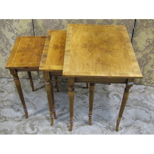 2299 - A graduated set of three occasional tables on reeded supports and swept feet, 50cm max