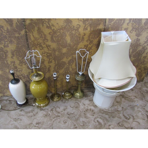 2353 - A mustard coloured ceramic table lamp of baluster form with brass fittings, a further oviform lamp i... 