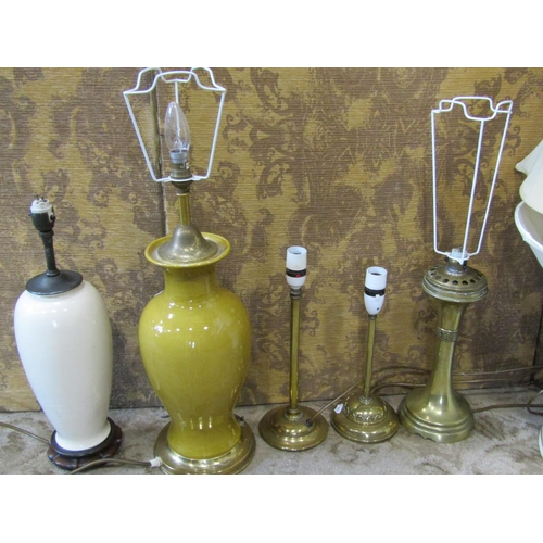 2353 - A mustard coloured ceramic table lamp of baluster form with brass fittings, a further oviform lamp i... 