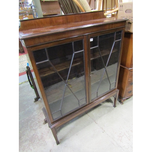 2377 - An Edwardian mahogany display cabinet on stand with astragal glazed panelled doors, raised on square... 