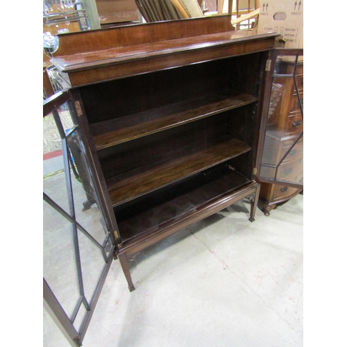 2377 - An Edwardian mahogany display cabinet on stand with astragal glazed panelled doors, raised on square... 