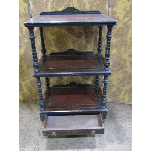 2384 - A Victorian three tier watnot with amboyna wood panels within an ebonised framework enclosing a lowe... 