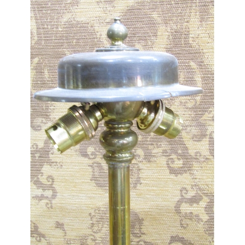 2388 - An Edwardian brass telescopic lamp standard, the circular base with lions paw feet