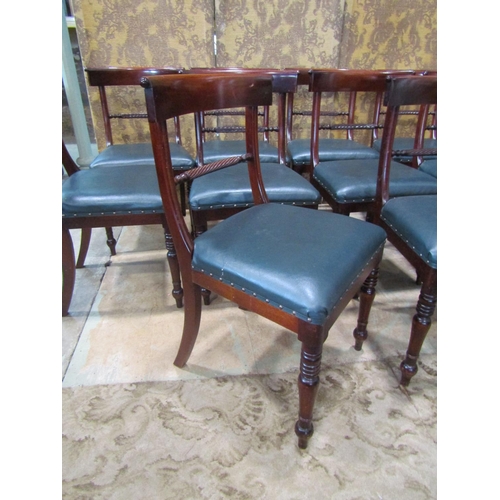 2168 - A set of ten Regency style mahogany curved bar back dining chairs with rope twist rails and upholste... 