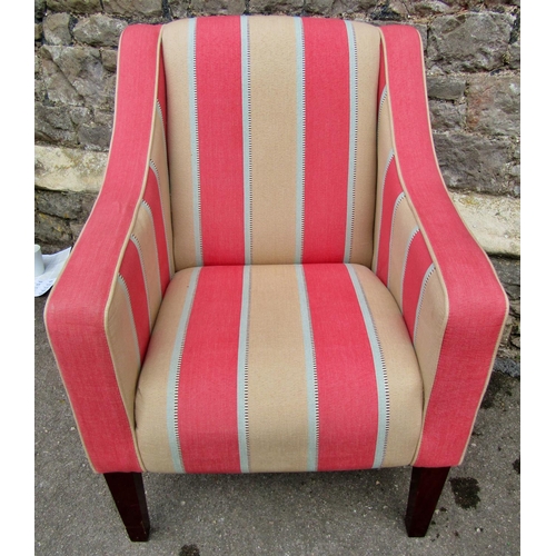 2317 - An upholstered easy chair in cream and pink striped material raised on square cut supports