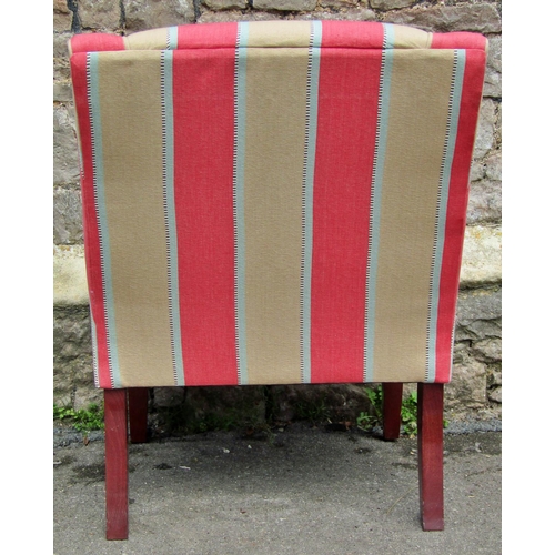 2317 - An upholstered easy chair in cream and pink striped material raised on square cut supports