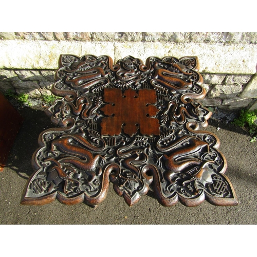 2392 - A Chinese square cut hardwood occasional table with deeply carved detail of wrythen dragons, raised ... 