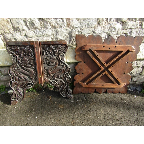 2392 - A Chinese square cut hardwood occasional table with deeply carved detail of wrythen dragons, raised ... 