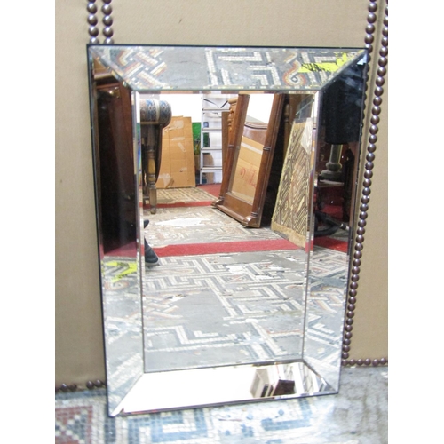 2408 - A contemporary wall mirror with bevelled edge plate within a further mirrored frame 80cm x 54cm