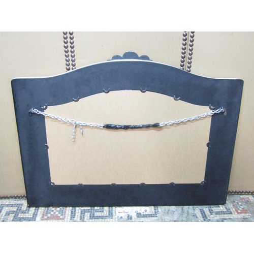 2425 - An overmantle mirror in a stepped and painted frame with arched outline, 83cm x 130cm