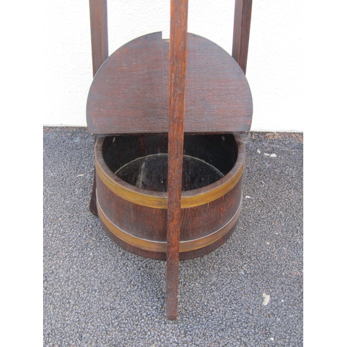 2494 - A Lister & Co work table in oak, the circular top raised on splay supports with enclosed base, a fur... 