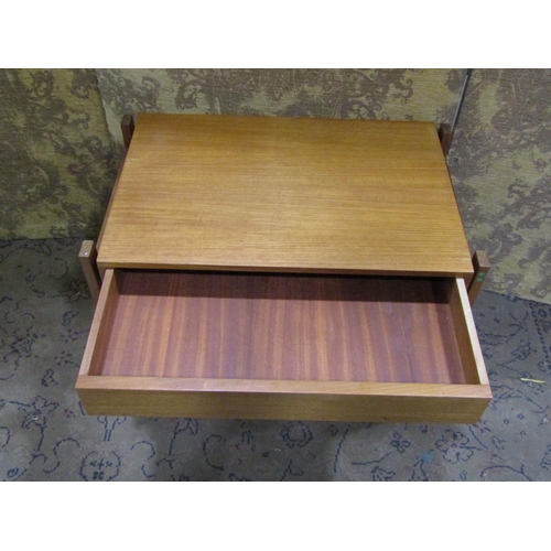 2202 - A low teak rectangular occasional table with frieze drawer raised on an open framework/supports, 62 ... 