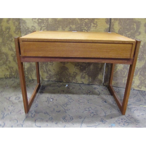 2202 - A low teak rectangular occasional table with frieze drawer raised on an open framework/supports, 62 ... 