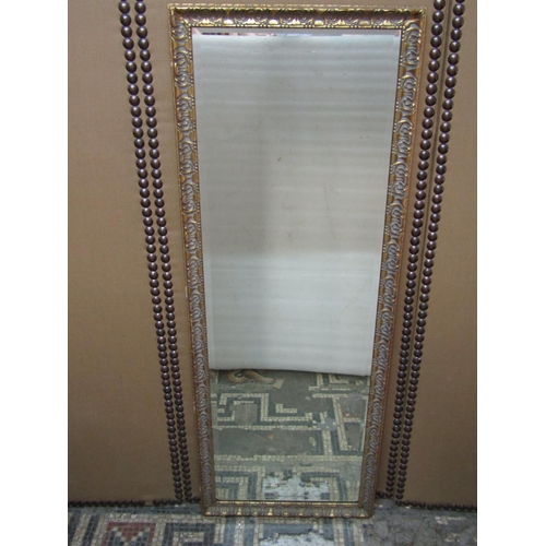 2427A - A rectangular wall mirror with bevelled edge plate and gilt moulded frame 120cm x 45cm