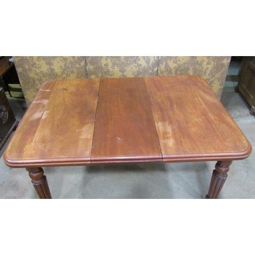 2277 - A Victorian mahogany extending dining table - cottage sized, raised on four turned and fluted suppor... 