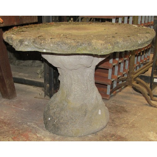 2510 - A weathered garden seat on a simulated trunk base, a number of terracotta pipes and a circular weath... 