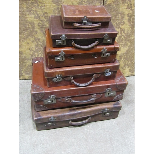 2175 - A mixed collection of six leather and other suitcases / luggage to include stitched examples with re... 