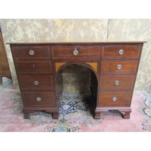 2665 - An Edwardian inlaid mahogany kneehole writing desk of nine drawers, the central arch with further in... 