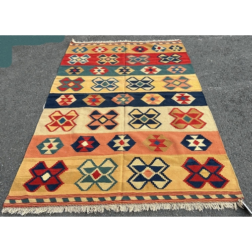 1773 - A southwest Persian Qashquai Kilim, with geometric design in tones of ochre, terracotta, and dark bl... 