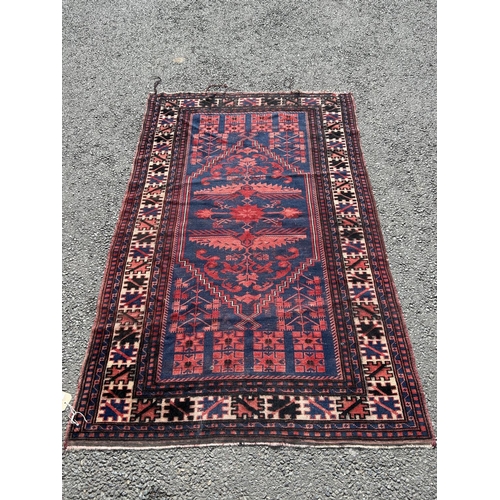 1776 - A Kasack carpet with a central stylised medallion on a red and blue ground, 188cm x 100cm