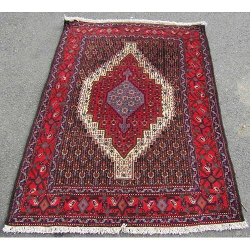 1786 - A north west Persian Senneh rug, with central stepped lozenge medallion, in blue, red and cream tone... 