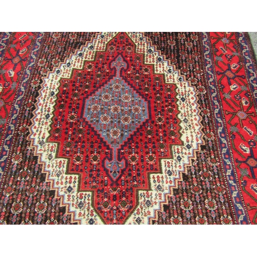 1786 - A north west Persian Senneh rug, with central stepped lozenge medallion, in blue, red and cream tone... 