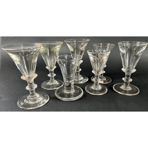 1111 - A selection of six similar Georgian baluster glasses with drawn trumpet bowls and a single glass wit... 