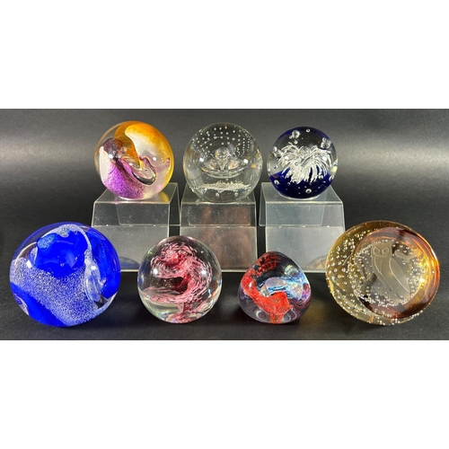 1115 - Seven Caithness paperweights, six of abstract design and one with an owl, three perspex stands inclu... 